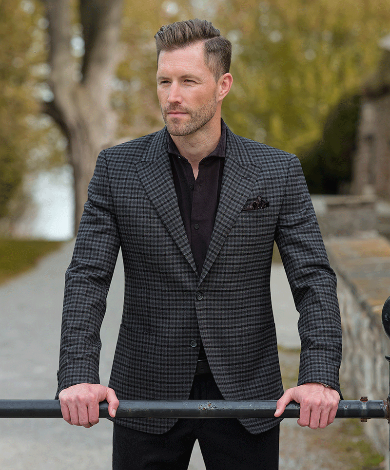 Man wearing a Black and charcoal check Italian wool stretch sport coat (cloth 27510) paired with 
black Attivo bi-stretch trousers (cloth 23415)