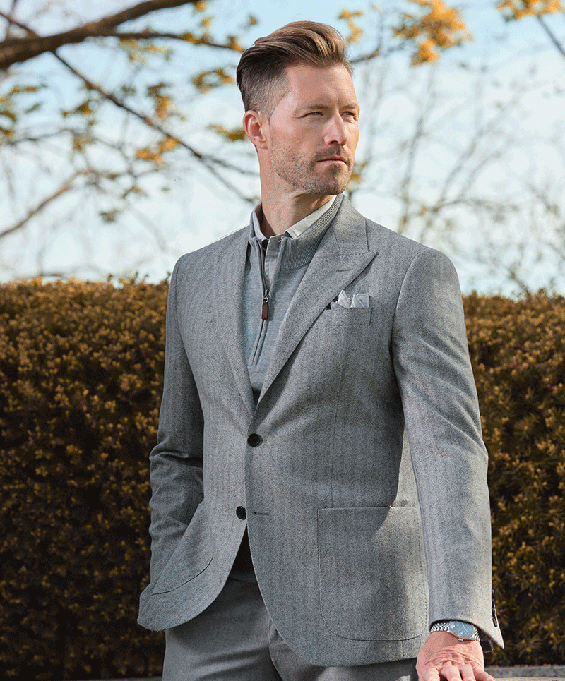 Light Grey herringbone 100% wool sport coat (cloth 27637) paired with dove Grey 
flannel trousers (cloth 6848). Fabric woven in Italy.