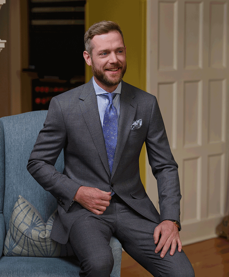 Man wearing a Grey Super 160’s wool suit with blue windowpane in cloth 26991. Fabric made in Italy. 