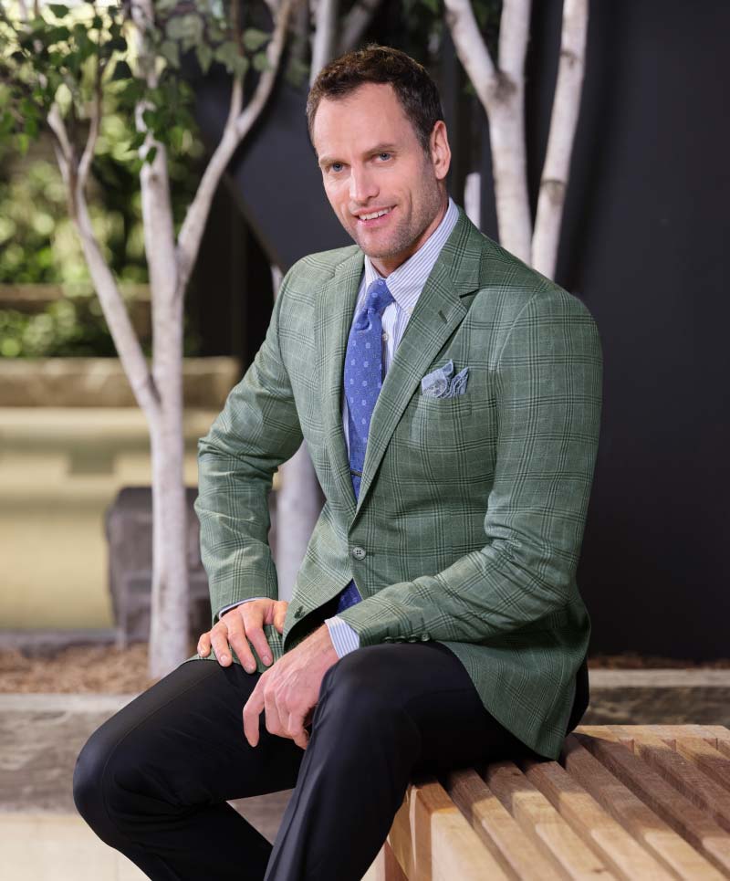 Man wearing Reda Super 130’s green and blue plaid sport coat (cloth # 27910) with dark navy
trousers (cloth # 60211)